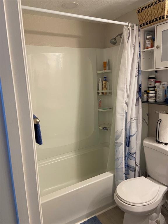 5343 Bluepoint Drive Port Richey, FL 34668 - Photo 19 of 28 a bathroom with a shower a toilet and a shower