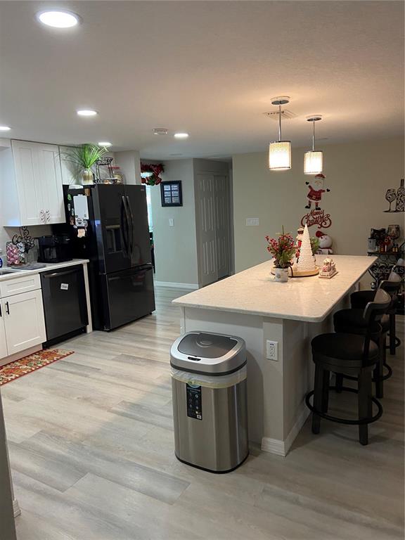 5343 Bluepoint Drive Port Richey, FL 34668 - Photo 20 of 28 a large kitchen with a table chairs and a refrigerator