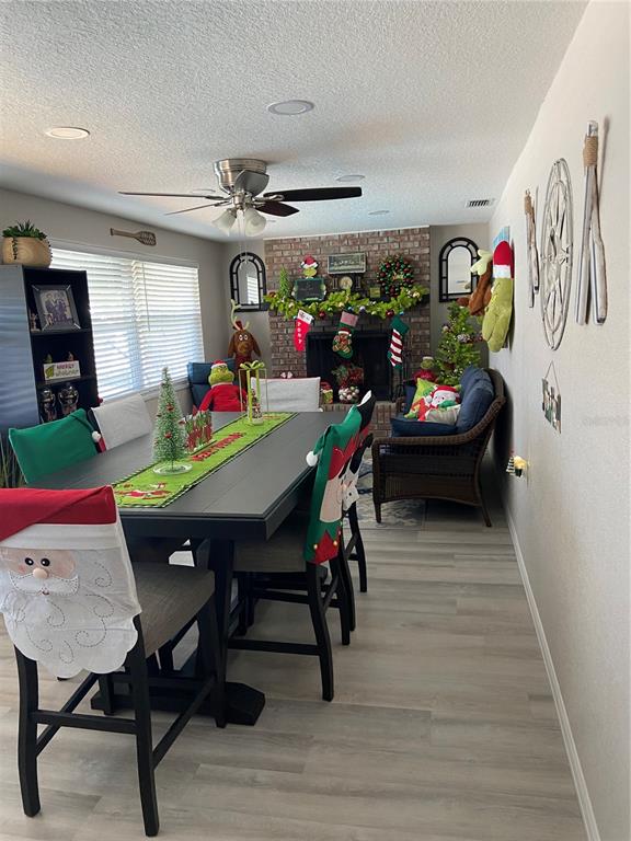 5343 Bluepoint Drive Port Richey, FL 34668 - Photo 21 of 28 a view of a dining room with furniture and wooden floor