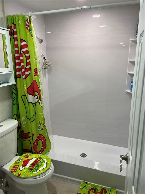 5343 Bluepoint Drive Port Richey, FL 34668 - Photo 22 of 28 a bathroom with a toilet and a shower