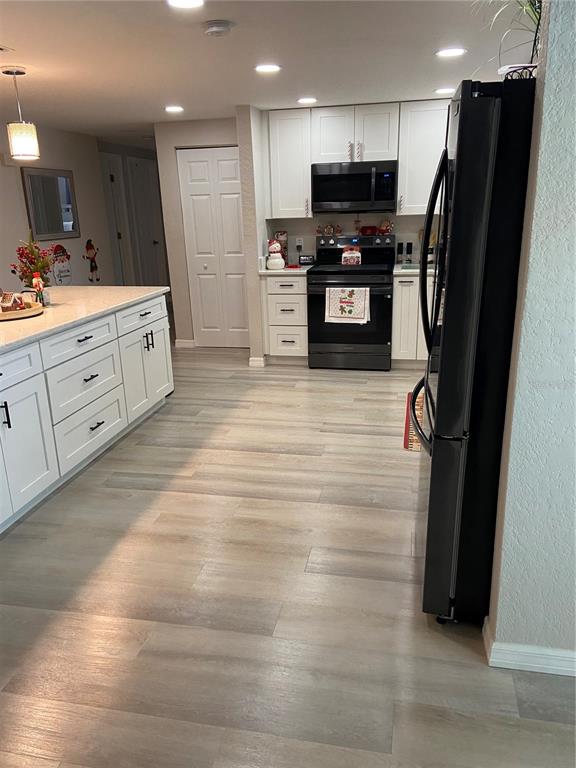 5343 Bluepoint Drive Port Richey, FL 34668 - Photo 24 of 28 a view of kitchen with stainless steel appliances kitchen island granite countertop a refrigerator oven a sink and dishwasher