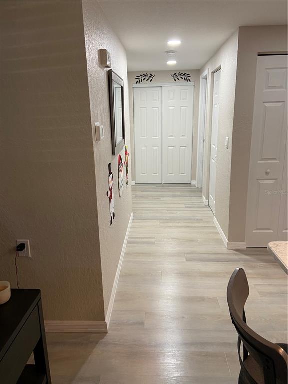 5343 Bluepoint Drive Port Richey, FL 34668 - Photo 26 of 28 a view of a hallway with wooden floor and entryway