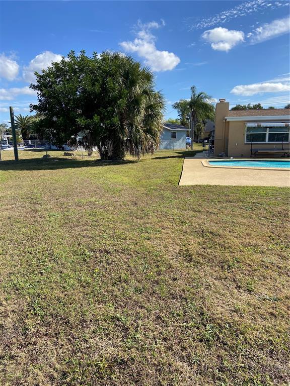 5343 Bluepoint Drive Port Richey, FL 34668 - Photo 9 of 28 a view of swimming pool with an outdoor seating and a yard
