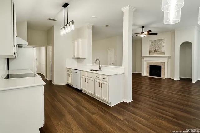 a kitchen with a sink and a stove top oven