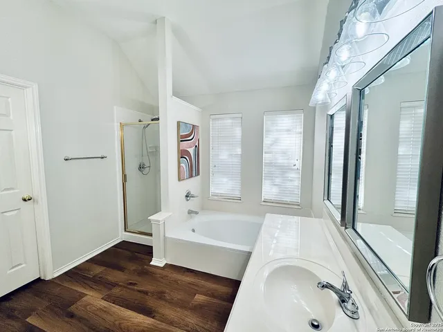 a bathroom with a tub sink and shower