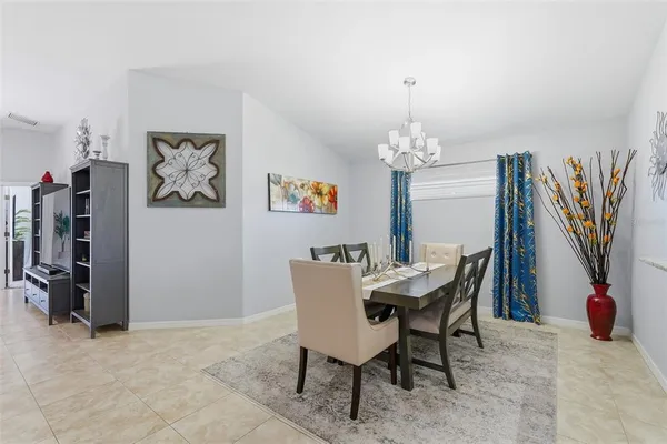 a view of a dining room with furniture and chandelier