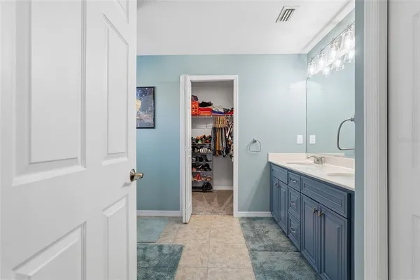 a bathroom with a double vanity sink mirror and shower