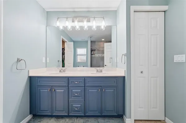 a bathroom with a granite countertop shower and sink