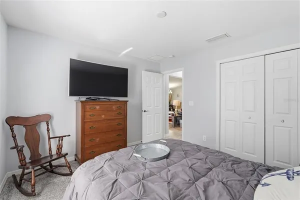 a living room with furniture and a ceiling fan