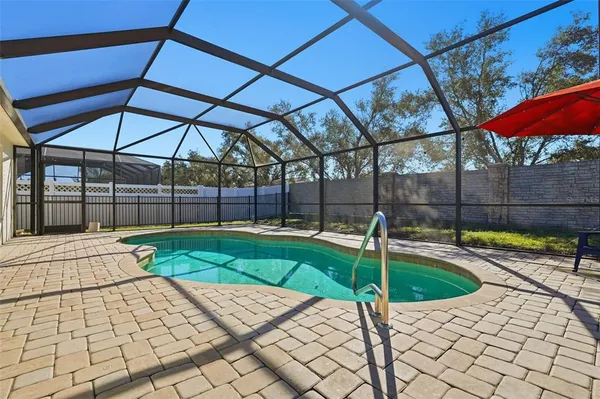 a view of swimming pool with a patio and a yard