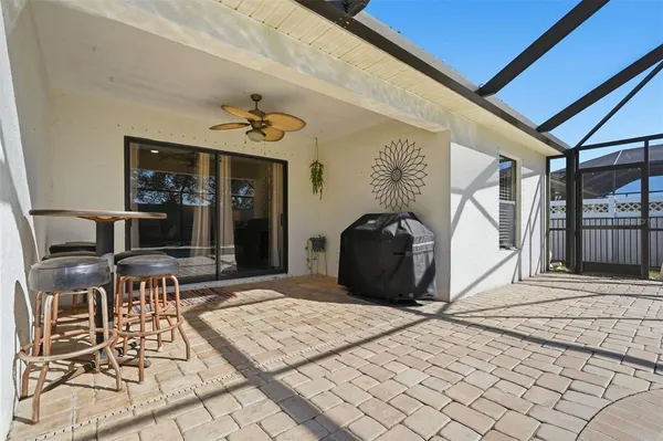 a view of a house with backyard and sitting area