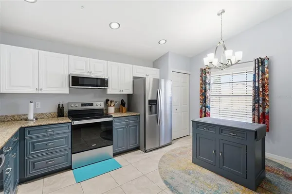 a kitchen with stainless steel appliances granite countertop a stove sink and refrigerator