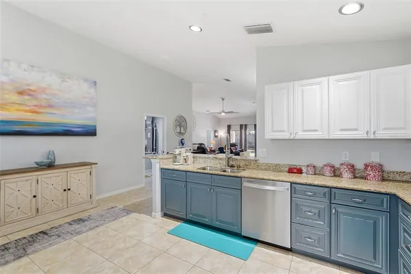 a kitchen with cabinets and window