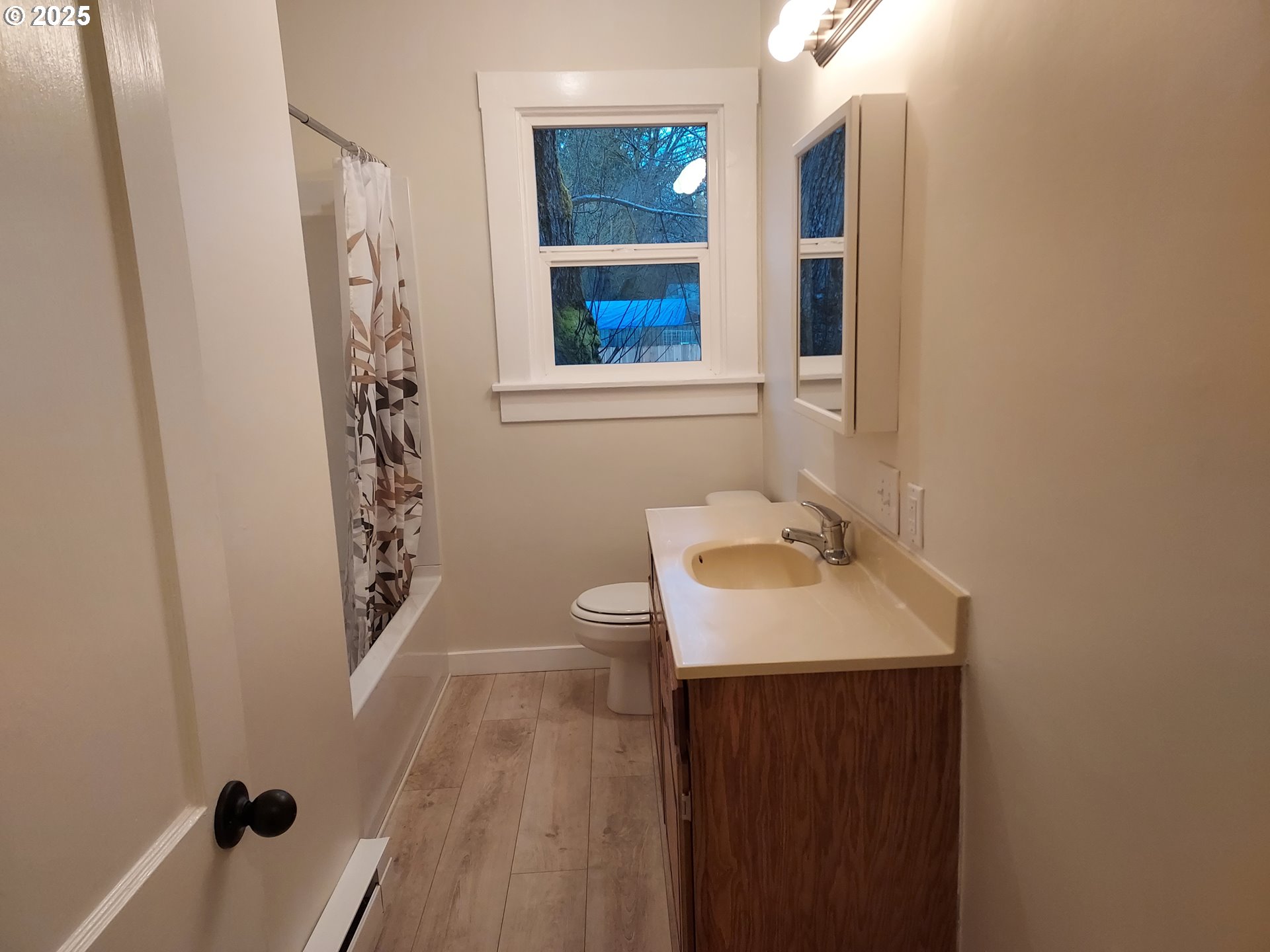 405 1/2 River Road Eugene, OR 97404 - Photo 9 of 18 a bathroom with a sink a toilet and a window