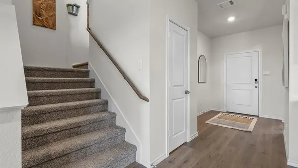 a view of entryway with stairs and wooden floor