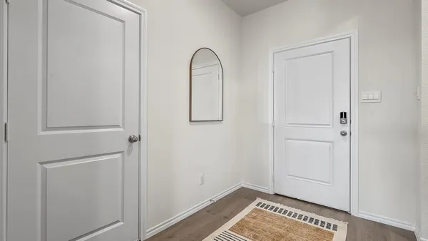 a view of an entryway with wooden floor