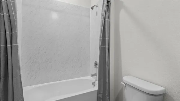 a bathroom with a shower and a toilet