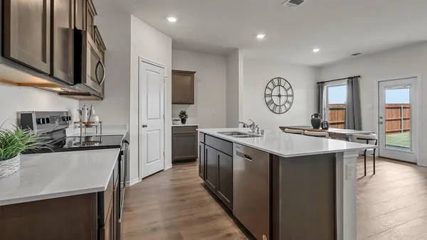 a kitchen with stainless steel appliances granite countertop a sink stove top oven and refrigerator