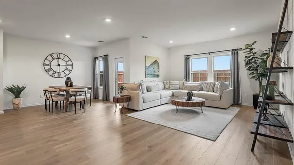 a living room with furniture and a potted plant