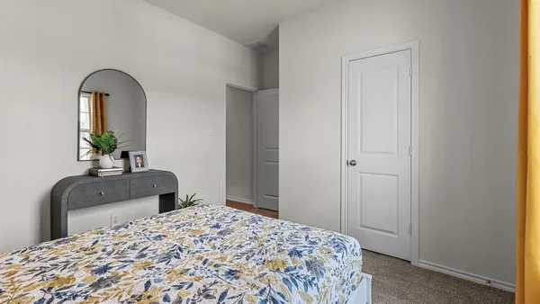a bedroom with a bed and a dresser