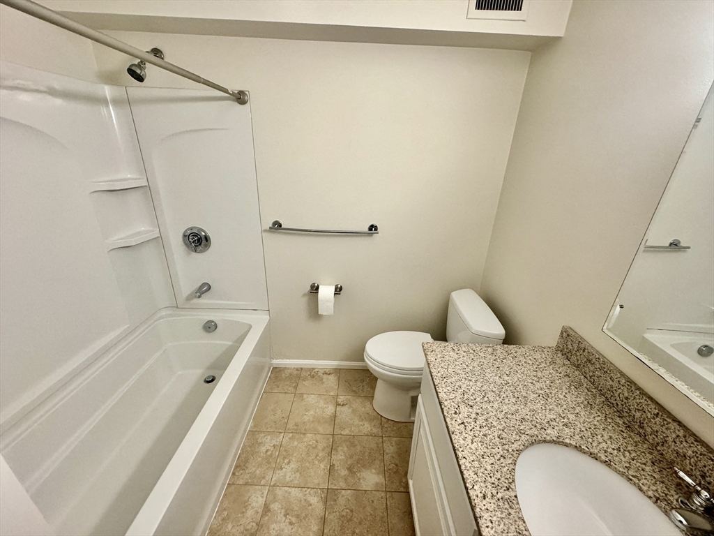 13 Beal's Cove Road, Unit E Hingham, MA 02043 - Photo 14 of 20 a bathroom with a granite countertop sink toilet and shower