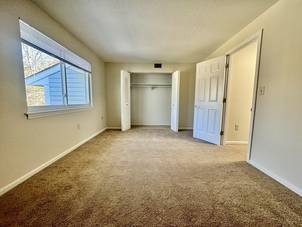 13 Beal's Cove Road, Unit E Hingham, MA 02043 - Photo 17 of 20 a view of an empty room with a window