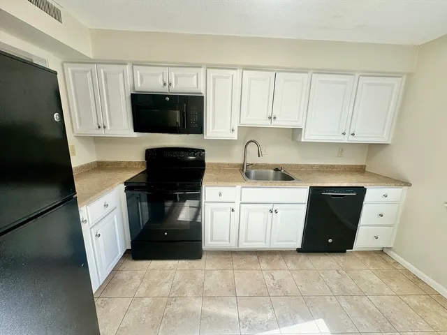 a kitchen with a sink and a stove top oven