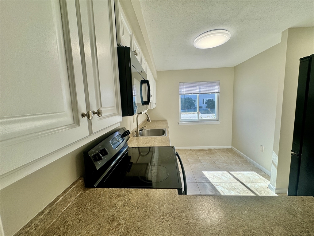 13 Beal's Cove Road, Unit E Hingham, MA 02043 - Photo 5 of 20 a view of a living room with windows