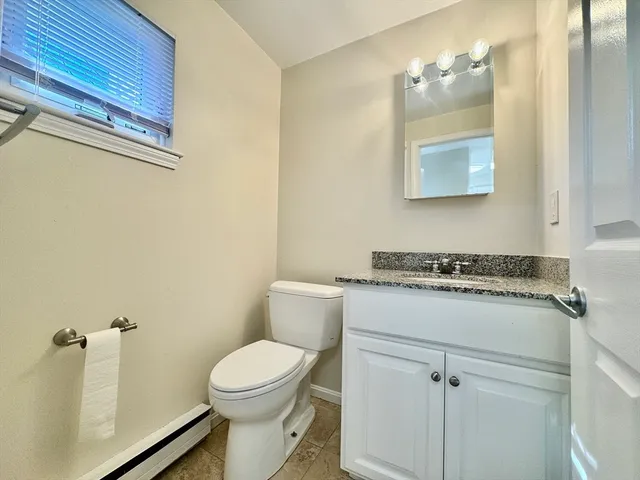 a bathroom with a sink a toilet and mirror