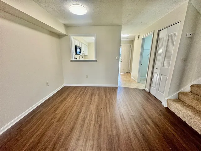 a view of a room with wooden floor and window