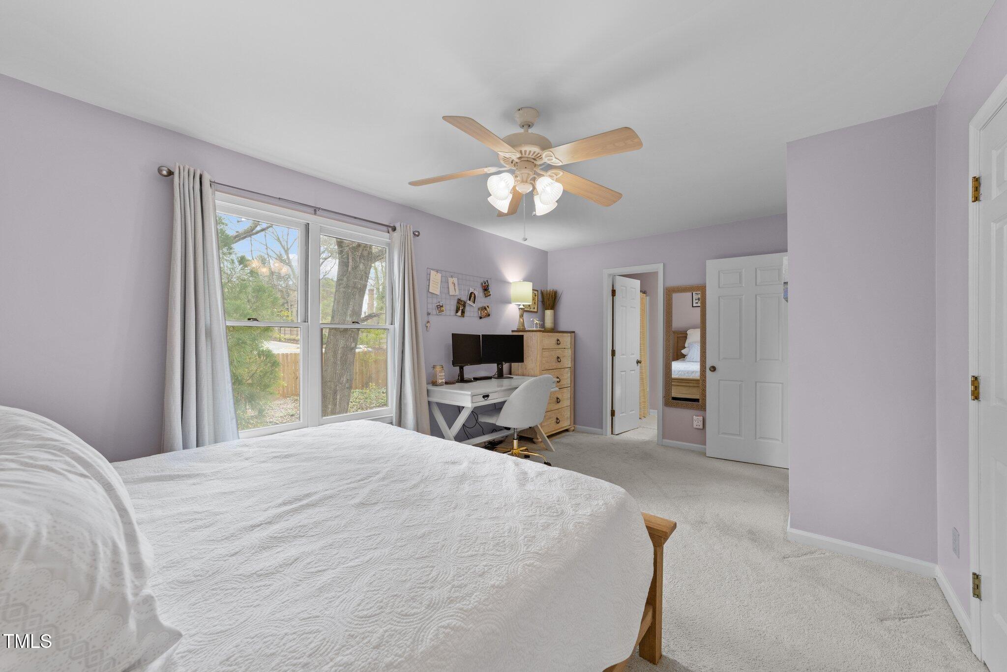 1334 Baez Street Raleigh, NC 27608 - Photo 14 of 28 a bedroom with a large bed and a chandelier
