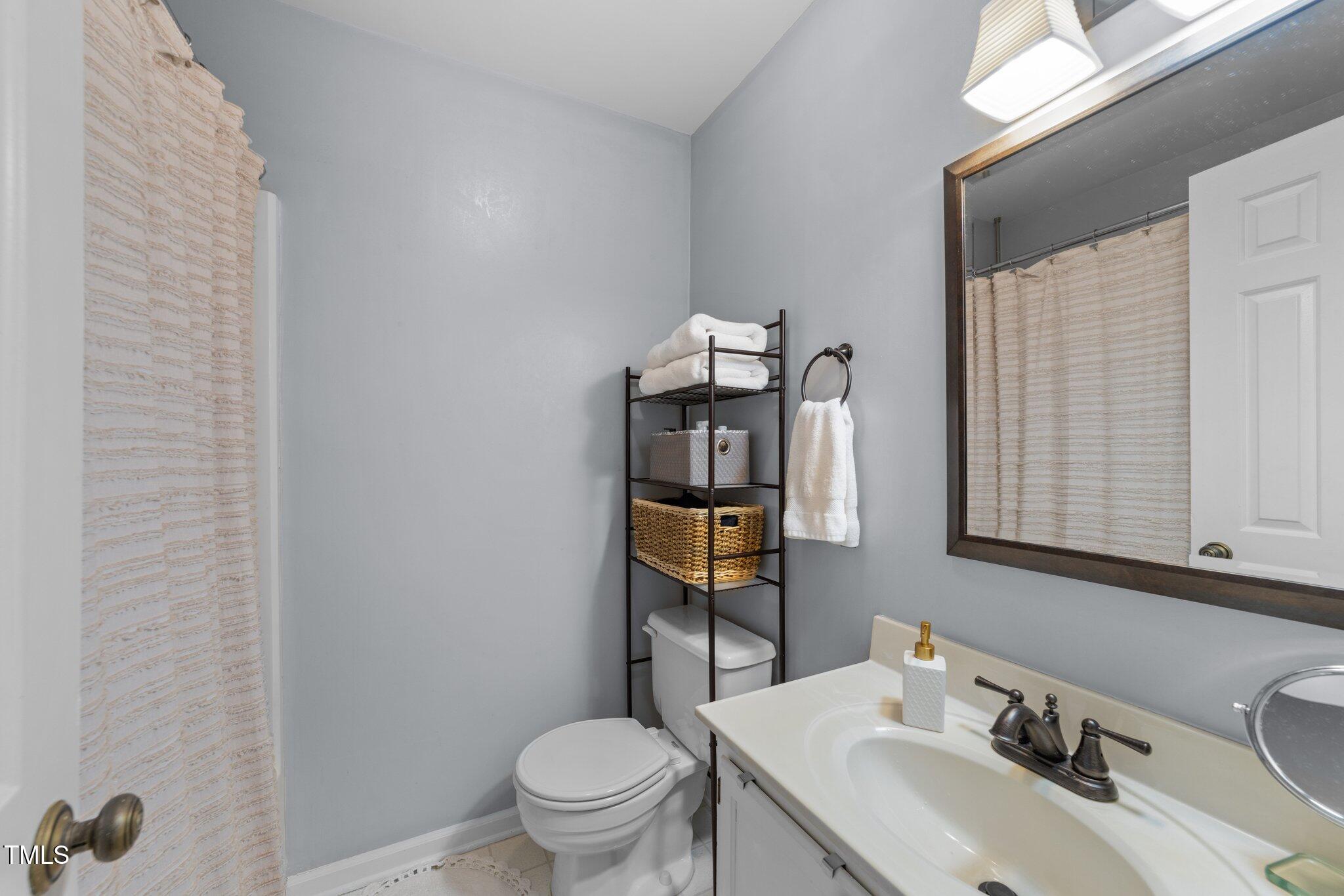 1334 Baez Street Raleigh, NC 27608 - Photo 15 of 28 a bathroom with a toilet sink and mirror