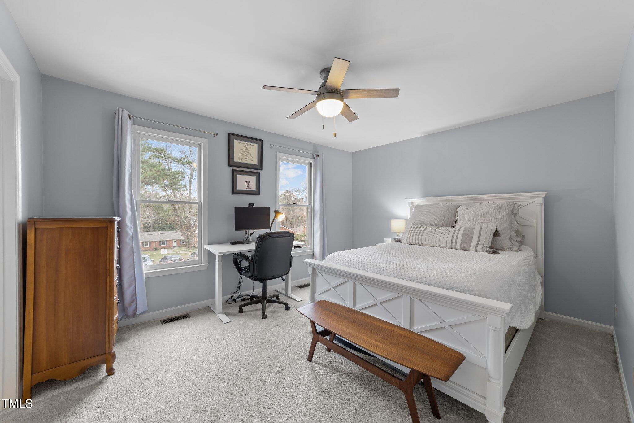 1334 Baez Street Raleigh, NC 27608 - Photo 16 of 28 a bedroom with a bed and a table