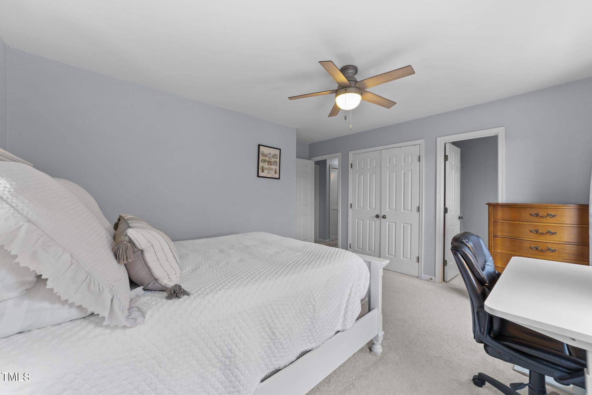 1334 Baez Street Raleigh, NC 27608 - Photo 17 of 28 a bedroom with a bed and a chandelier
