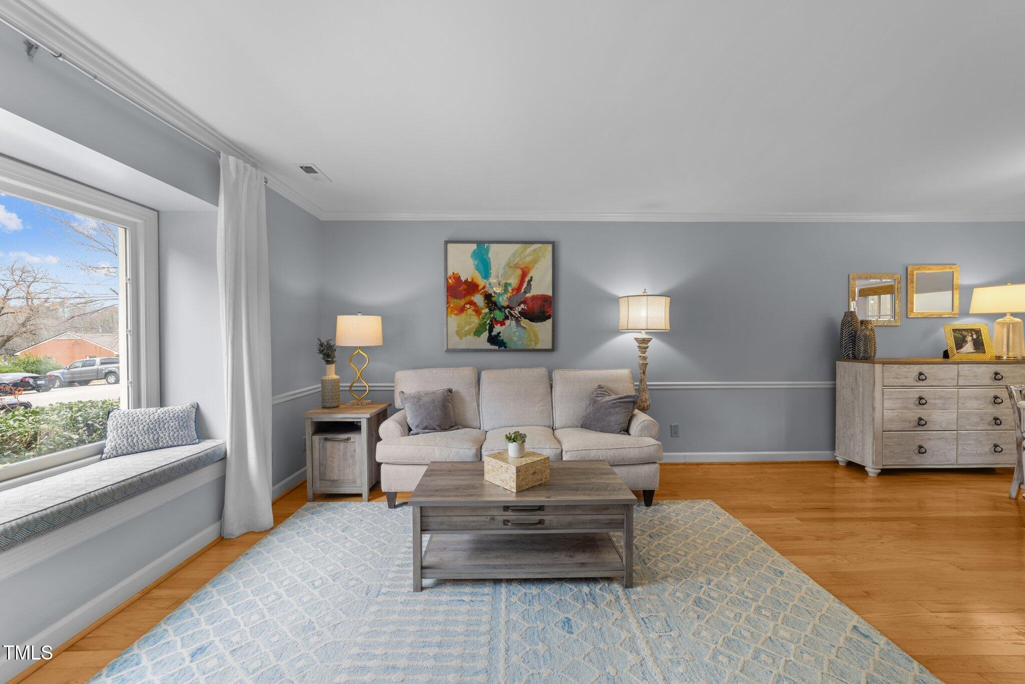 1334 Baez Street Raleigh, NC 27608 - Photo 5 of 28 a living room with furniture and a large window