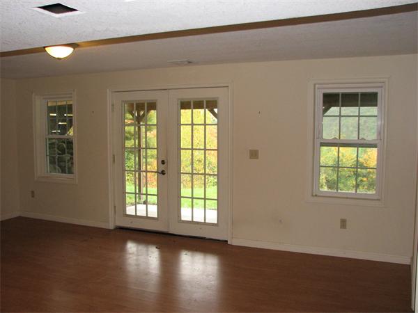 579 Old Warren Road Palmer, MA 01069 - Photo 18 of 27 an empty room with wooden floor and windows