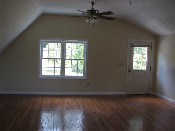 579 Old Warren Road Palmer, MA 01069 - Photo 5 of 27 an empty room with wooden floor closet fan and windows