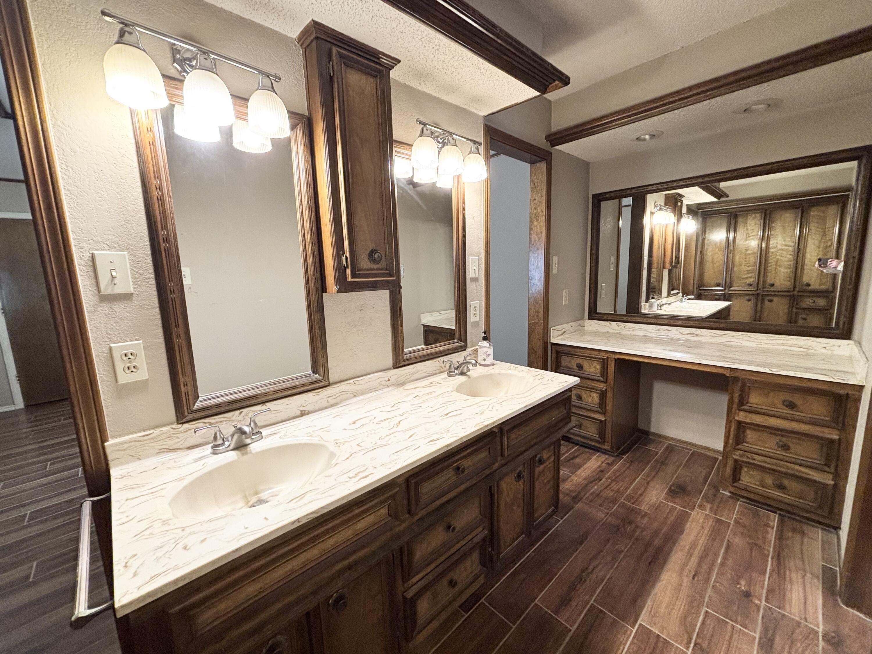 4913 62nd Street Lubbock, TX 79414 - Photo 12 of 22 a bathroom with a sink double vanity and a mirror