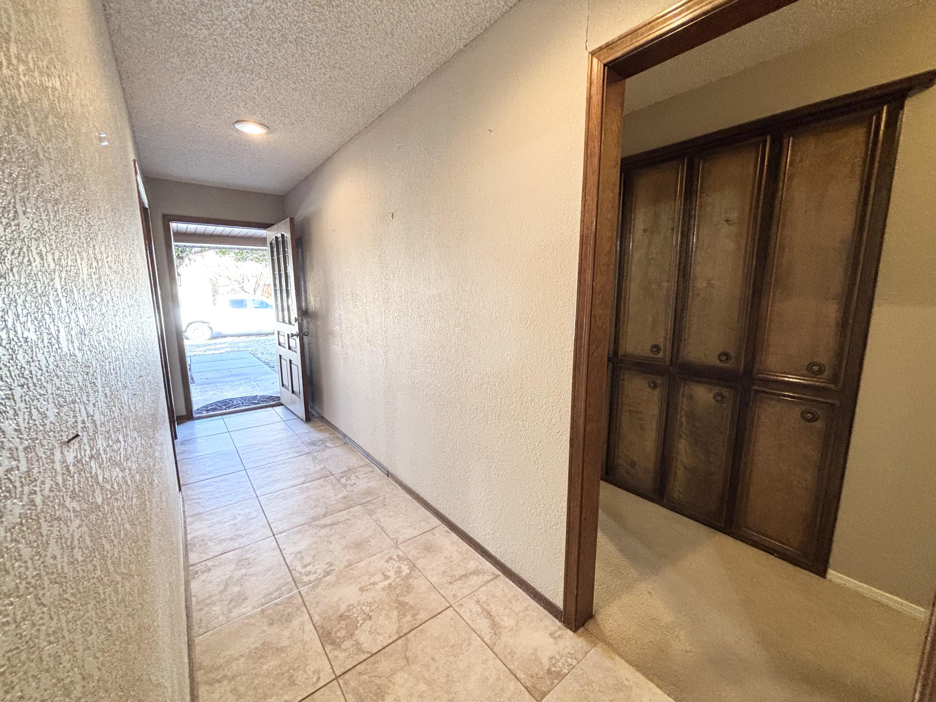4913 62nd Street Lubbock, TX 79414 - Photo 13 of 22 a view of hallway with wooden floor and cabinet