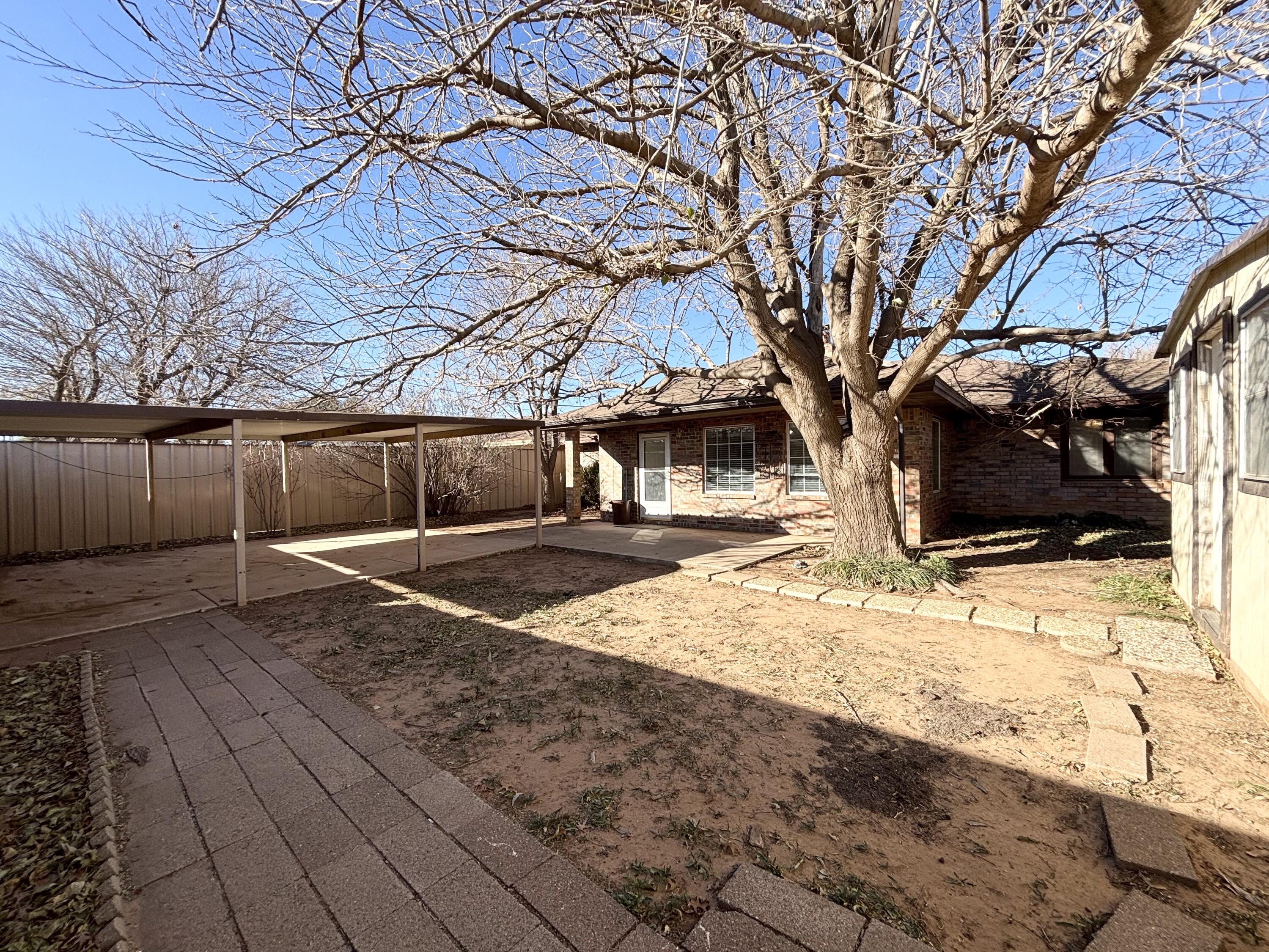4913 62nd Street Lubbock, TX 79414 - Photo 20 of 22 a view of a yard with wooden fence