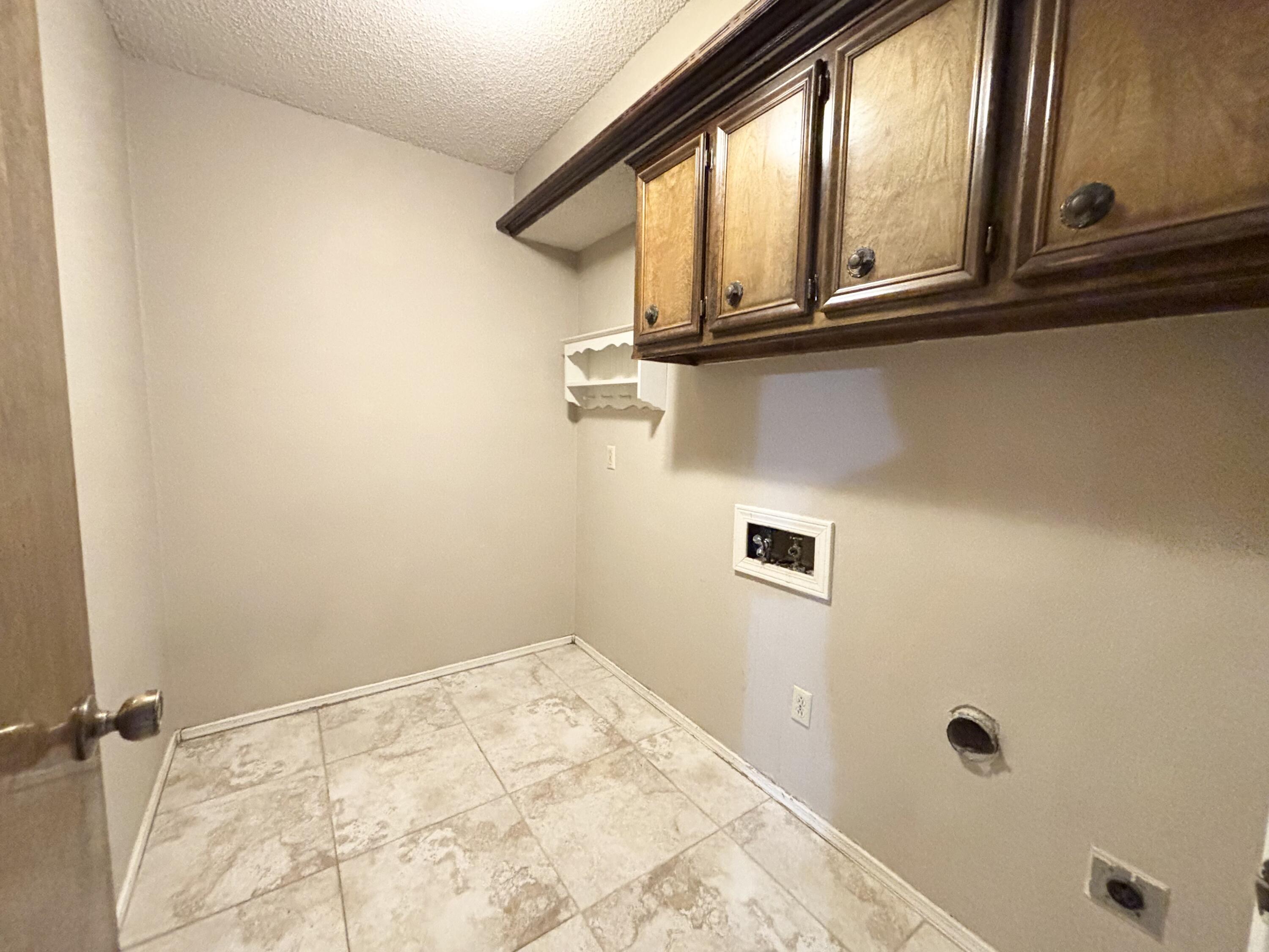 4913 62nd Street Lubbock, TX 79414 - Photo 22 of 22 a bathroom with a window sink and vanity