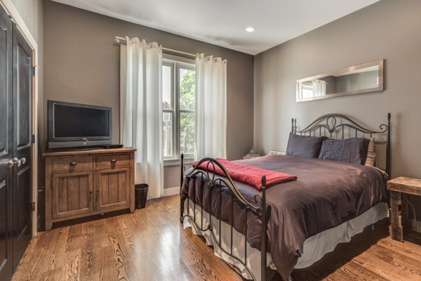 45 Vinton Street, Unit 5 Boston, MA 02127 - Photo 11 of 14 a bedroom with a bed and a flat screen tv