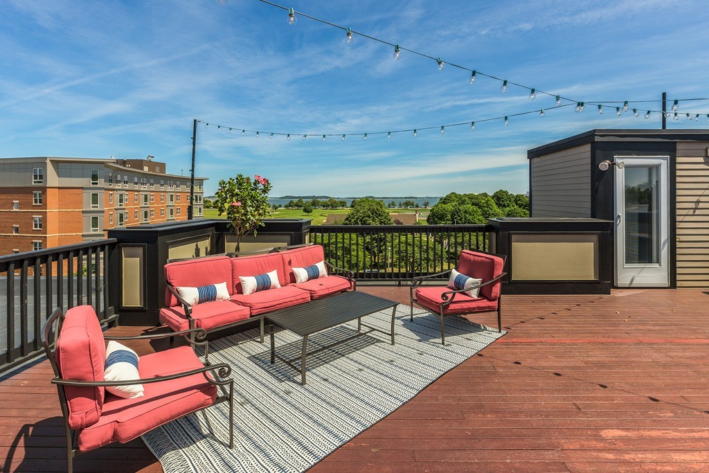 45 Vinton Street, Unit 5 Boston, MA 02127 - Photo 13 of 14 an outdoor sitting area with furniture and a fireplace