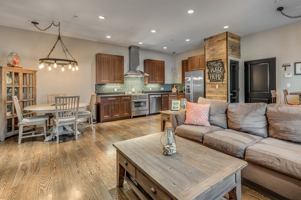 45 Vinton Street, Unit 5 Boston, MA 02127 - Photo 6 of 14 a living room with kitchen island furniture and a chandelier