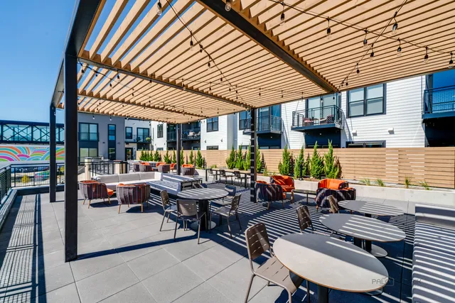a view of a patio with table and chairs with wooden floor and fence