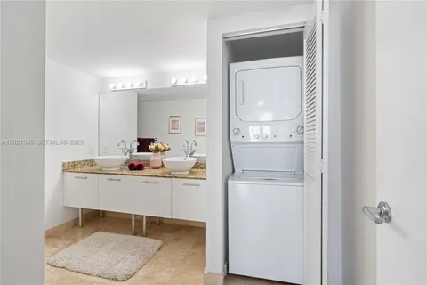 a room with a table chairs and entryway