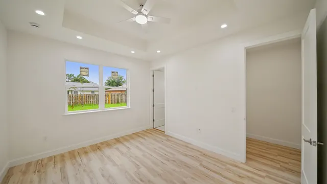 wooden floor in an empty room with a window