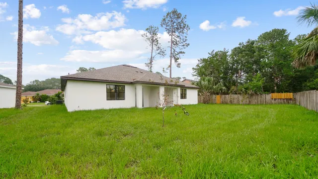 a view of a house with a backyard