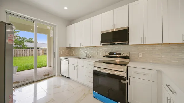 a kitchen with a sink stove and microwave