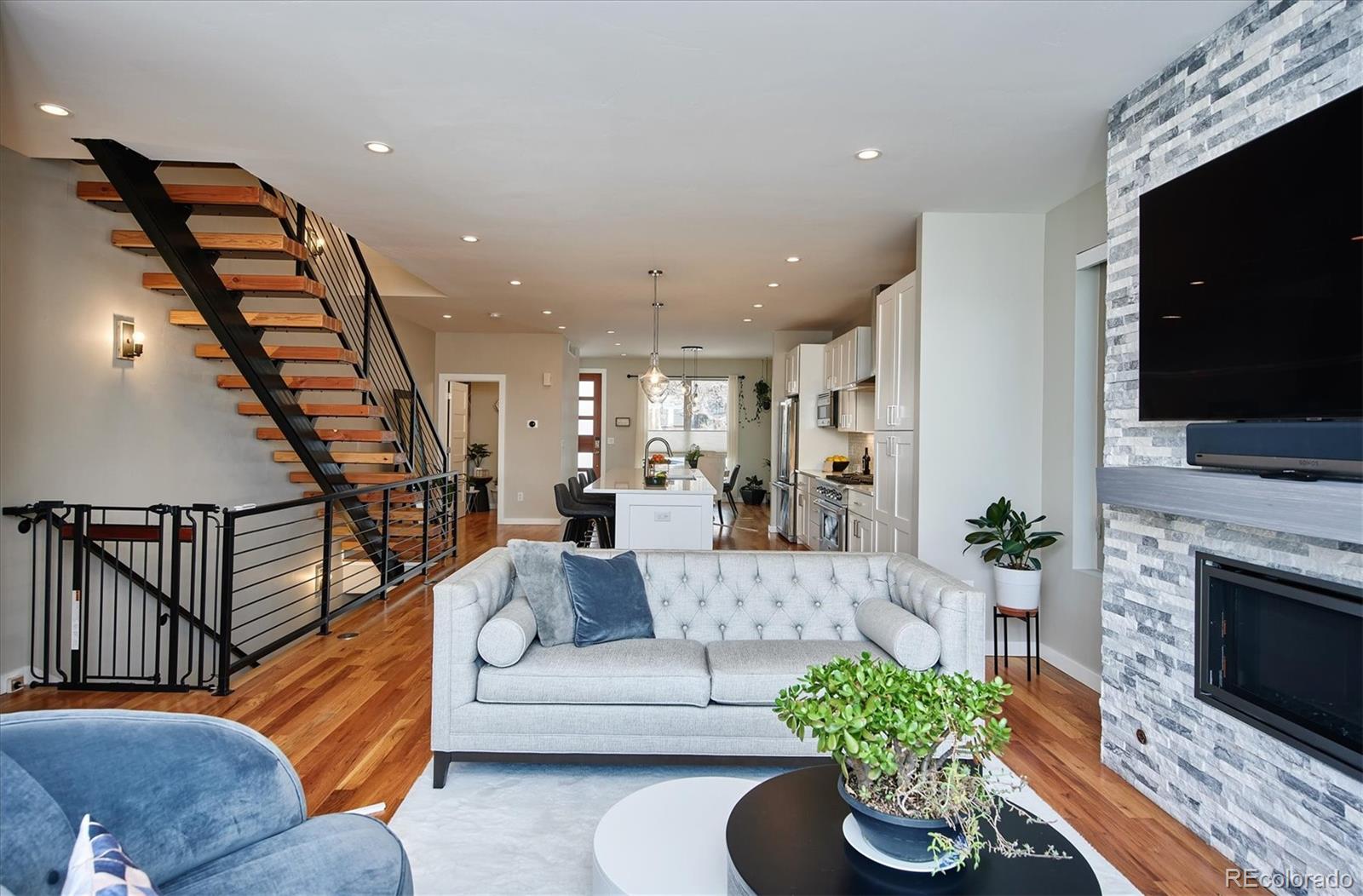 4583 Utica Street Denver, CO 80212 - Photo 13 of 40 a living room with furniture fireplace and a flat screen tv